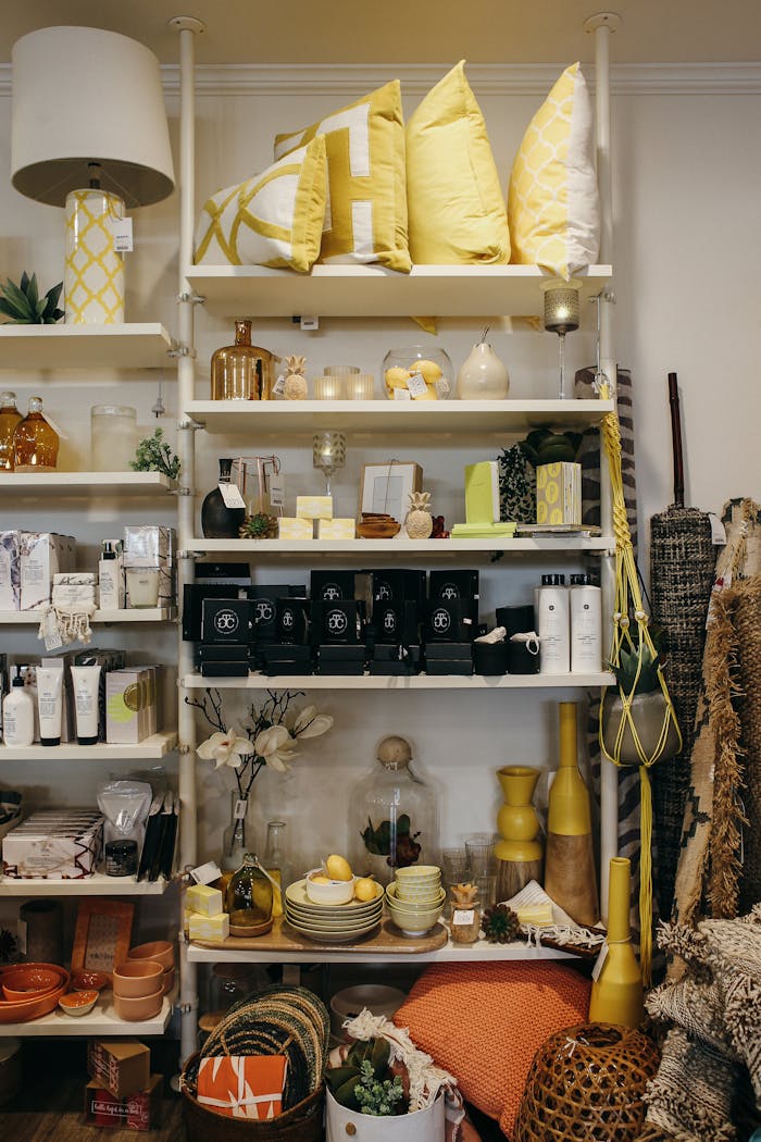 Stylish arrangement of household goods including pillows and decor in a cozy store setting.